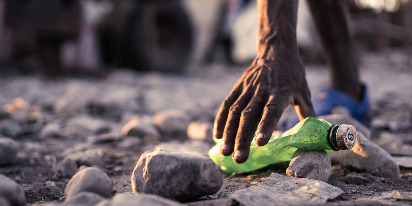 Picking up a plastic bottle