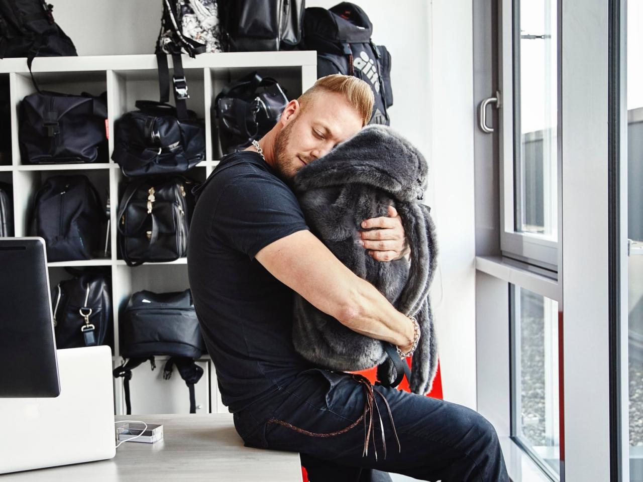 PUMA Creative Director Stuart Adams hugging a bag